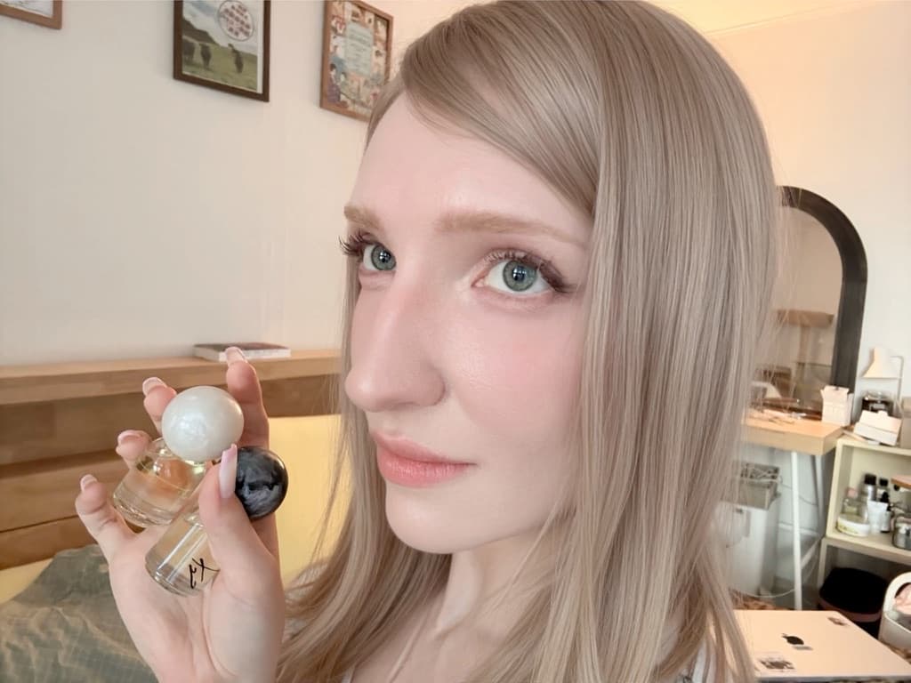 Portrait with two small perfume bottles
